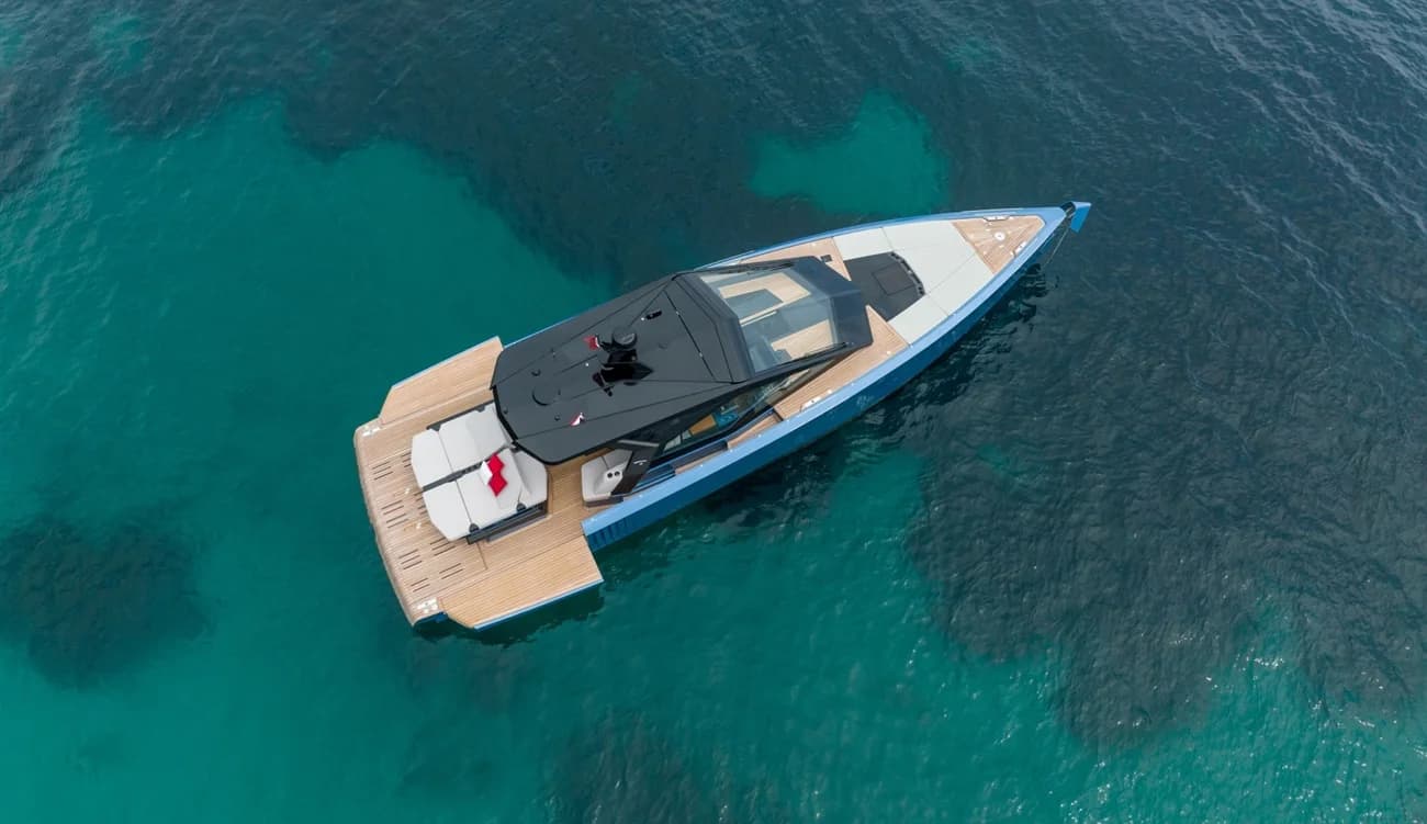 Aerial view of a motor yacht anchored in clear turquoise water